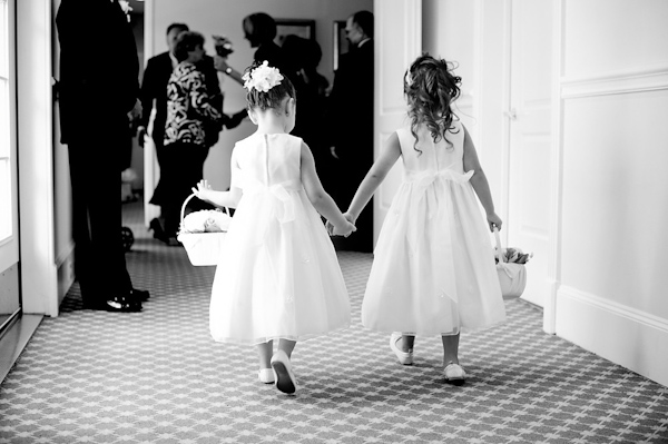 adorable flower girls walking hand in hand - photo by Houston based wedding photographer Adam Nyholt